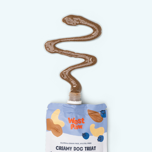 West Paw creamy dog treat packaging with a wavy line of brown treat on a white background