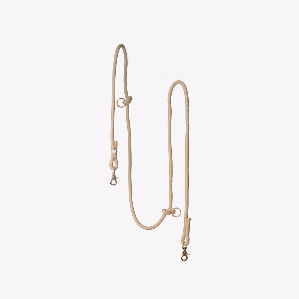 Beige leather dog leash on a white background