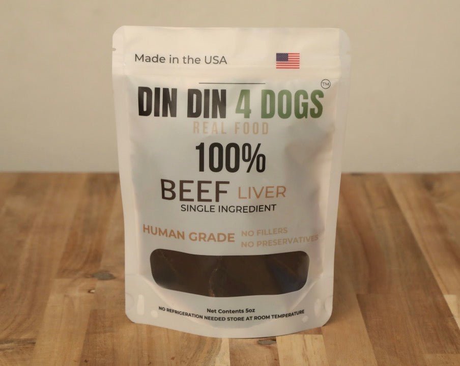 Package of DIN DIN 4 DOGS 100% Beef Liver dog food on a wooden surface.