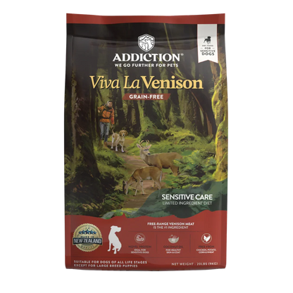 A bag of Addiction Viva La Venison grain-free dog food for sensitive care, featuring a forest illustration with deer and a dog on the front packaging.