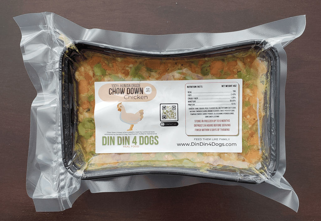 Package of Din Din 4 Dogs chicken food on a brown background