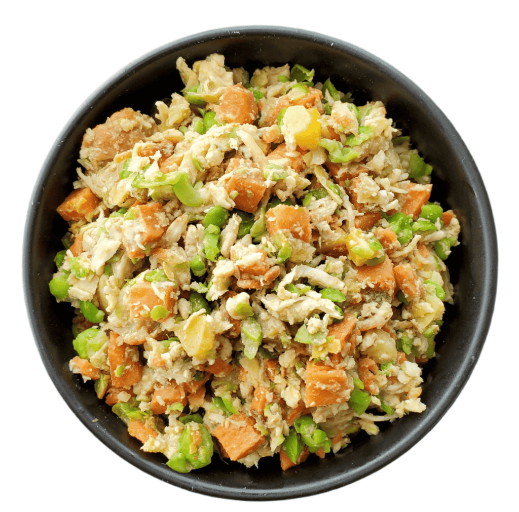 Black bowl filled with a rice salad containing carrots and green beans on a white background