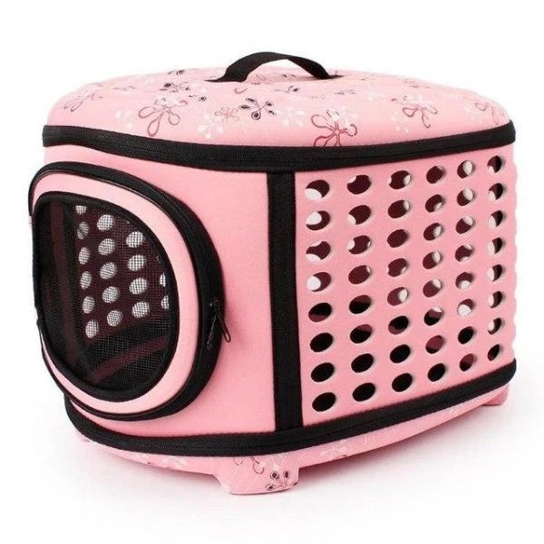 Pink pet carrier with black accents on a white background