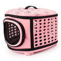 Pink pet carrier with black accents on a white background
