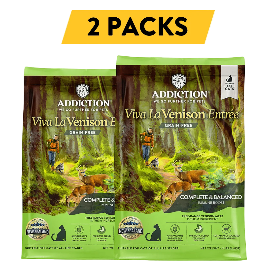 Two packs of Addiction Viva La Venison Entrée grain-free cat food with a forest background.