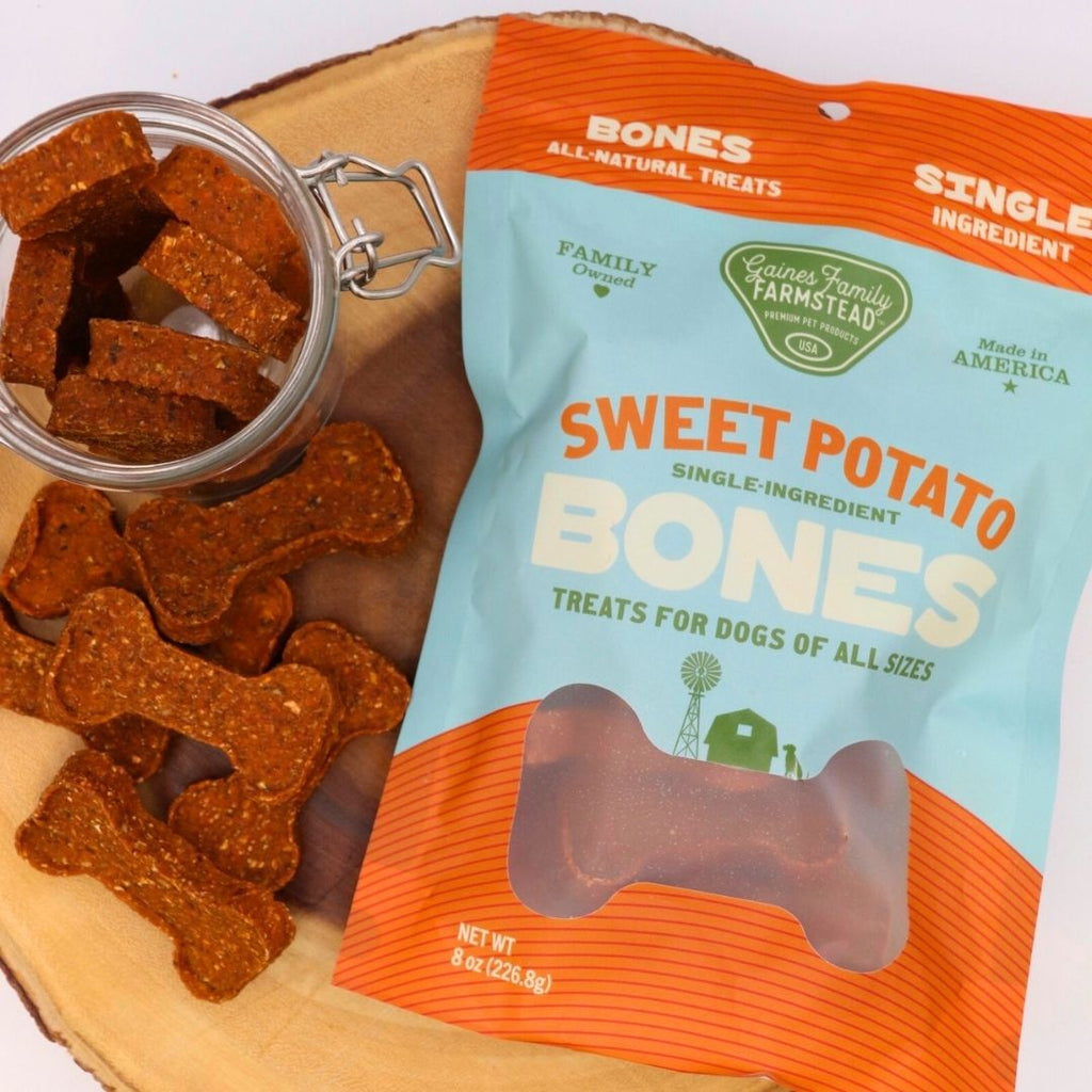 Sweet potato dog treats with packaging on a wooden surface