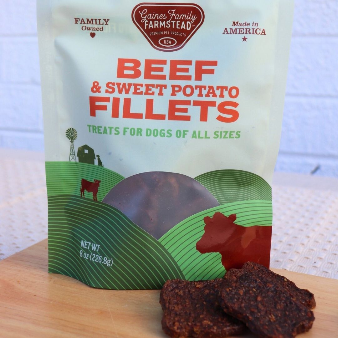 Package of Beef & Sweet Potato Fillets for dogs with treats displayed in front