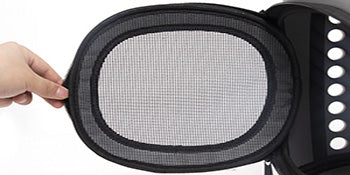 Close-up of a black mesh filter held by a hand against a white background