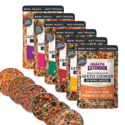 Multiple packages of Health Extension pet food with visible ingredients.