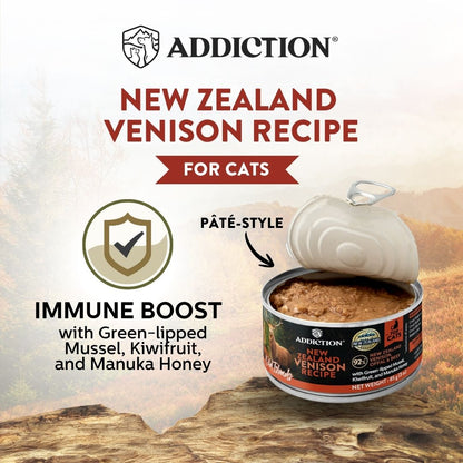 Addiction New Zealand Venison Recipe cat food can with promotional text on a scenic background