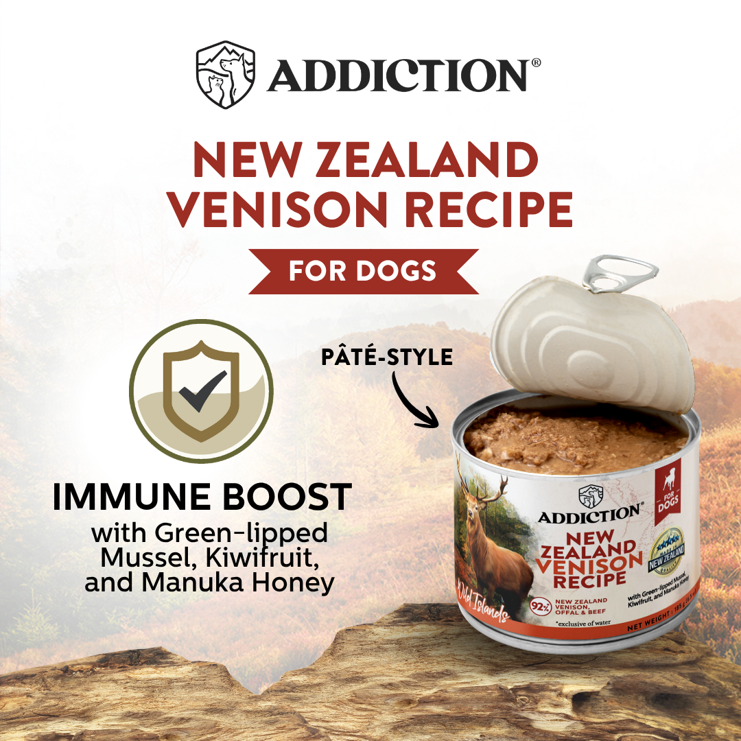 Addiction New Zealand Venison Recipe for dogs can on a wooden surface with branding and product details.