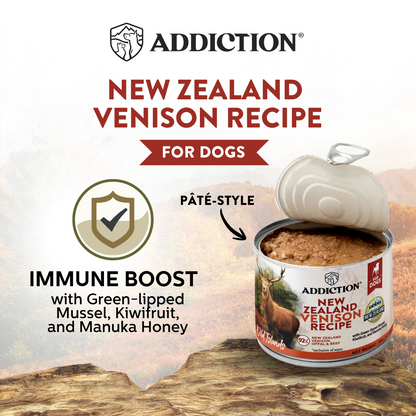 Addiction New Zealand Venison Recipe for dogs can on a wooden surface with branding and product details.