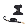 Black dog harness and leash set on a white background