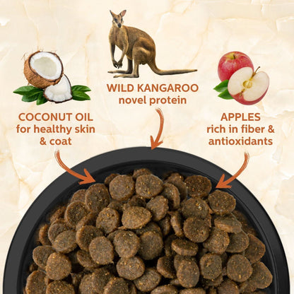 Dog food with ingredients labeled including wild kangaroo, coconut oil, and apples on a beige background.