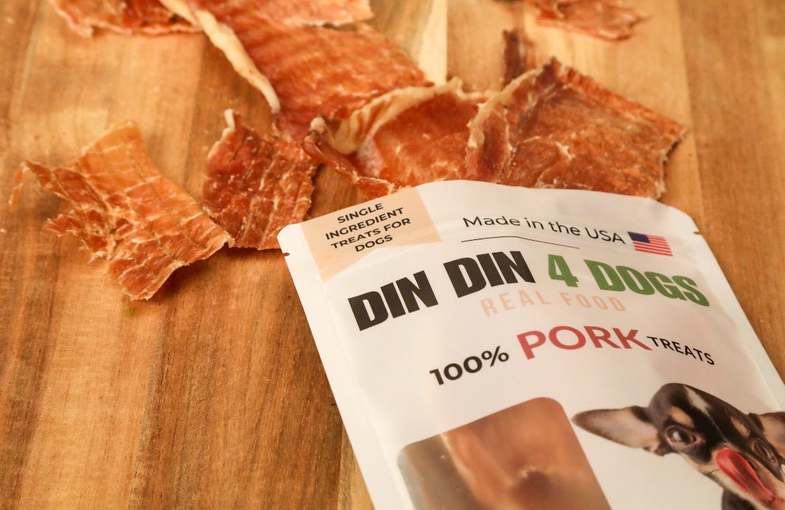 DIN DIN 4 DOGS pork treats on a wooden surface