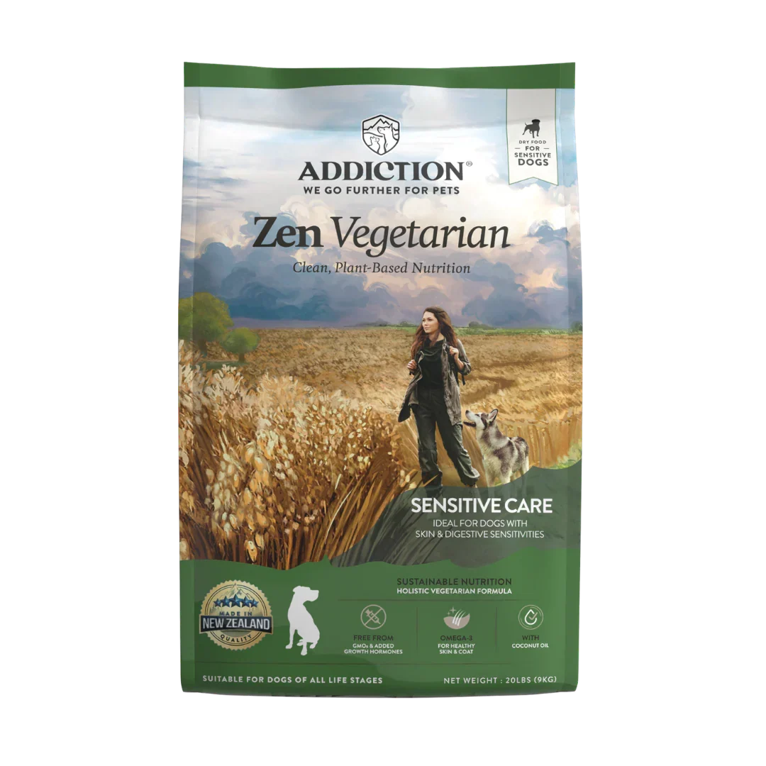 A bag of Addiction Zen Vegetarian Sensitive Care dog food, featuring a scenic image of a woman walking her dog through a wheat field with mountains in the background, set against a plain white backdrop.