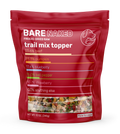 Red package of Bare Naked freeze-dried raw trail mix topper on a white background