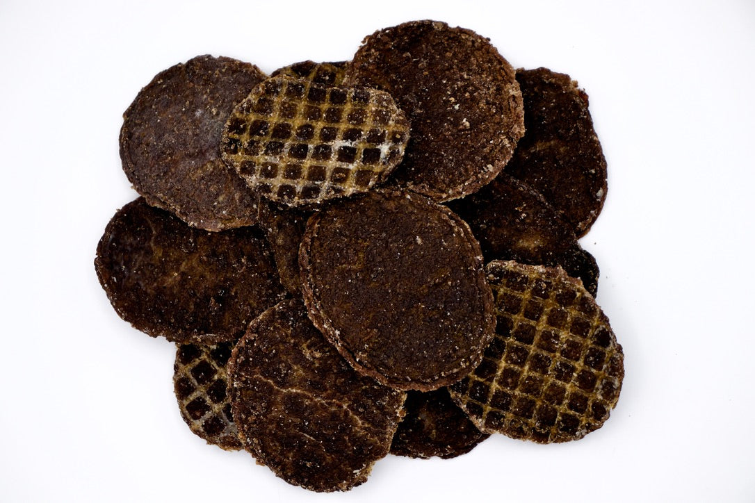Stack of brown circular objects with textured surface on a white background