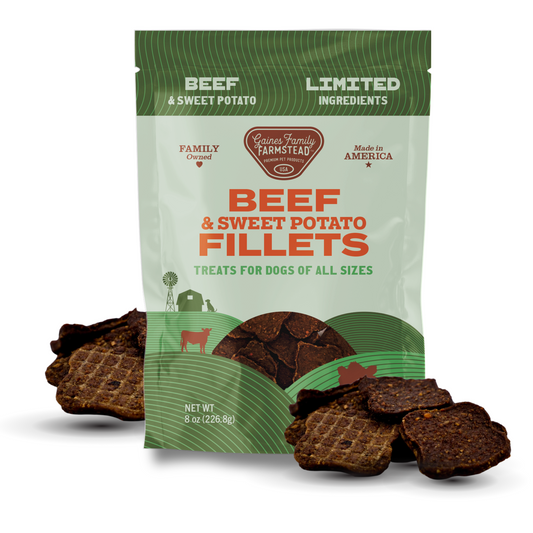 Package of beef and sweet potato fillets for dogs with visible treats on a white background