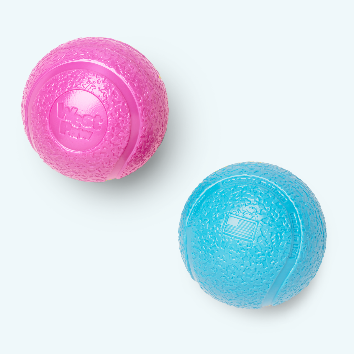 Pink and blue textured balls on a white background