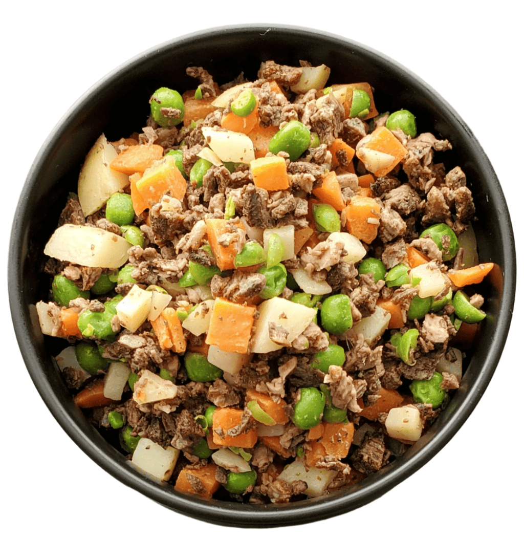 Black bowl filled with ground meat, carrots, peas, and onions on a white background