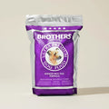 Brothers Ultra Premium Dog Food package on a beige background