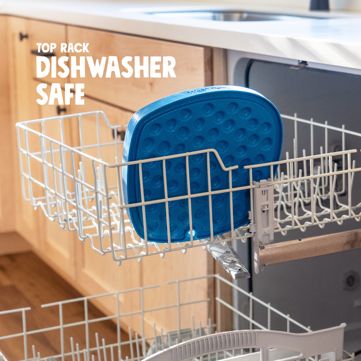 Blue silicone mat in a dishwasher rack with text 'Top Rack Dishwasher Safe'.