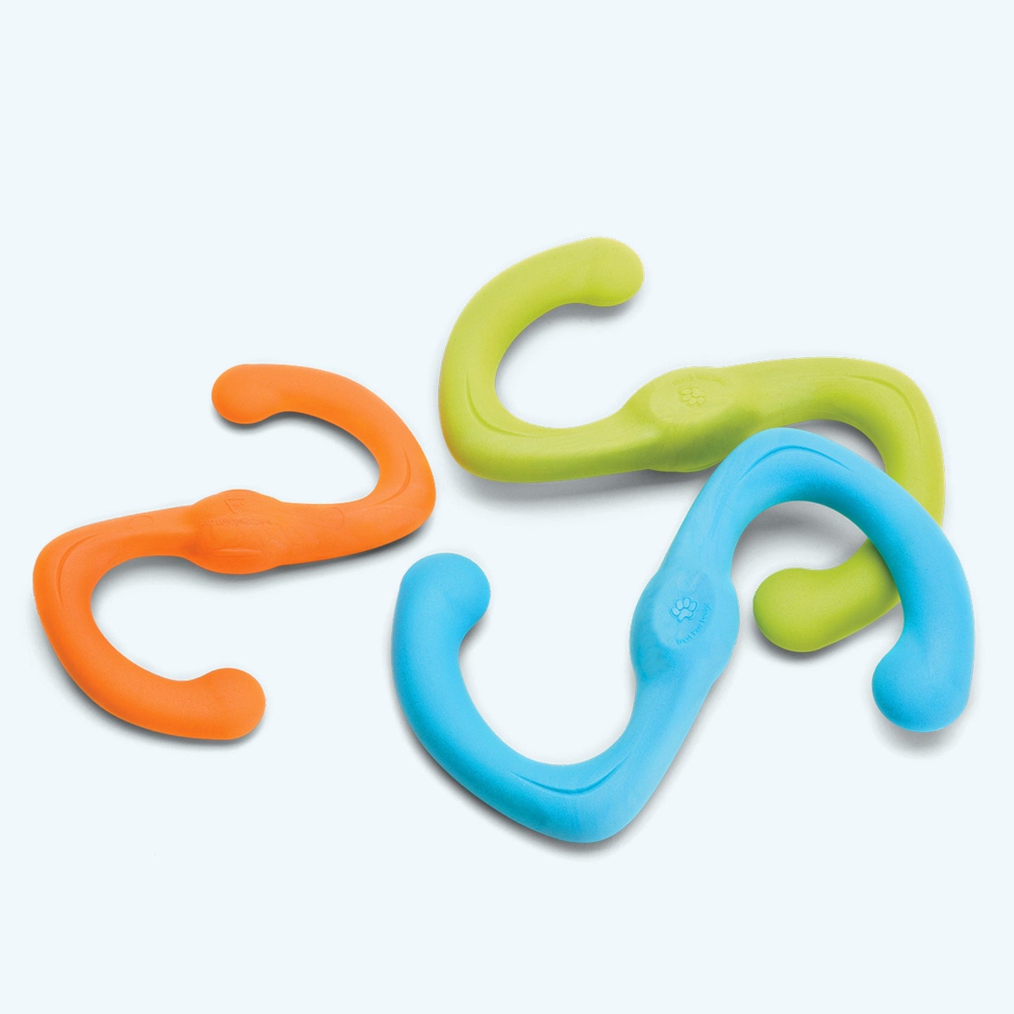 Three colorful plastic hooks in orange, green, and blue on a white background