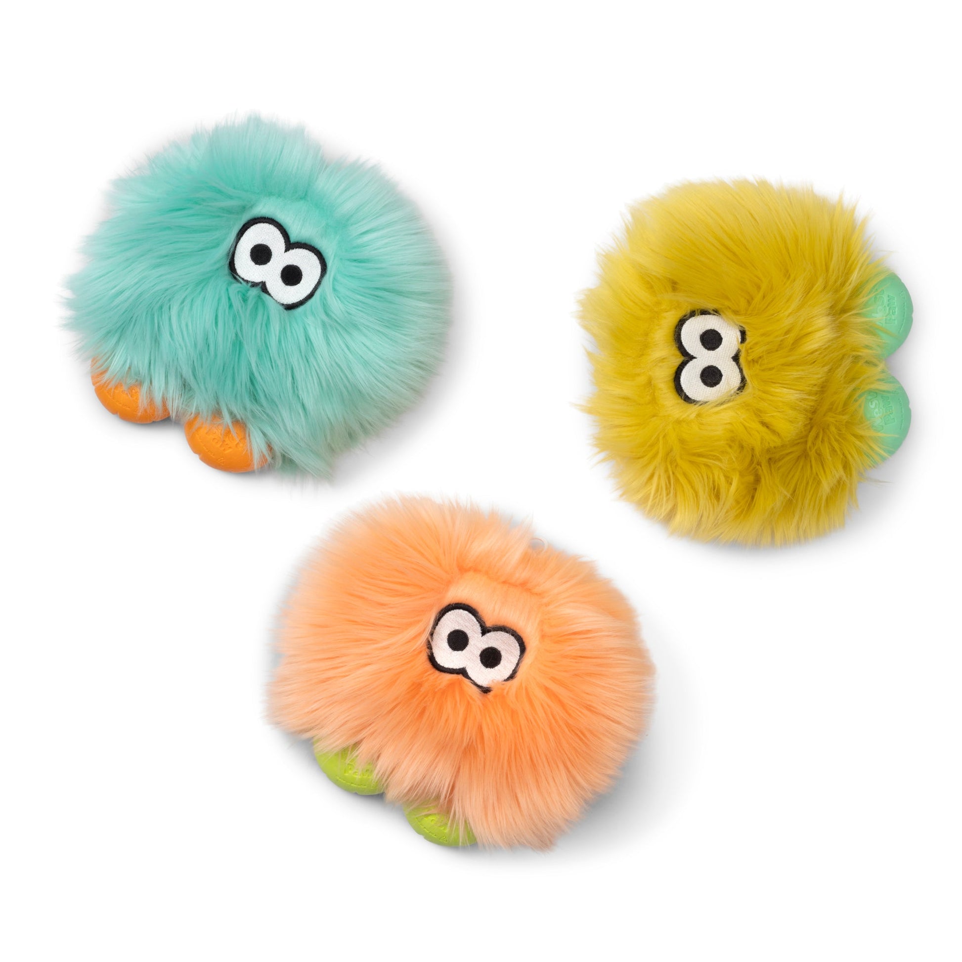 Three fluffy monster-shaped plush toys on a white background, each with large cartoon eyes and small colored feet. The toys are turquoise, yellow, and peach-orange.