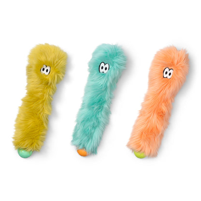 Three colorful fur toys with eyes on a white background