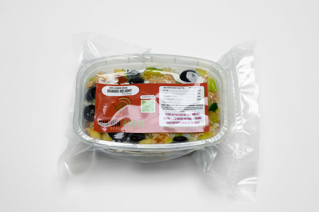 Packaged salad in a clear container with a label on a white background