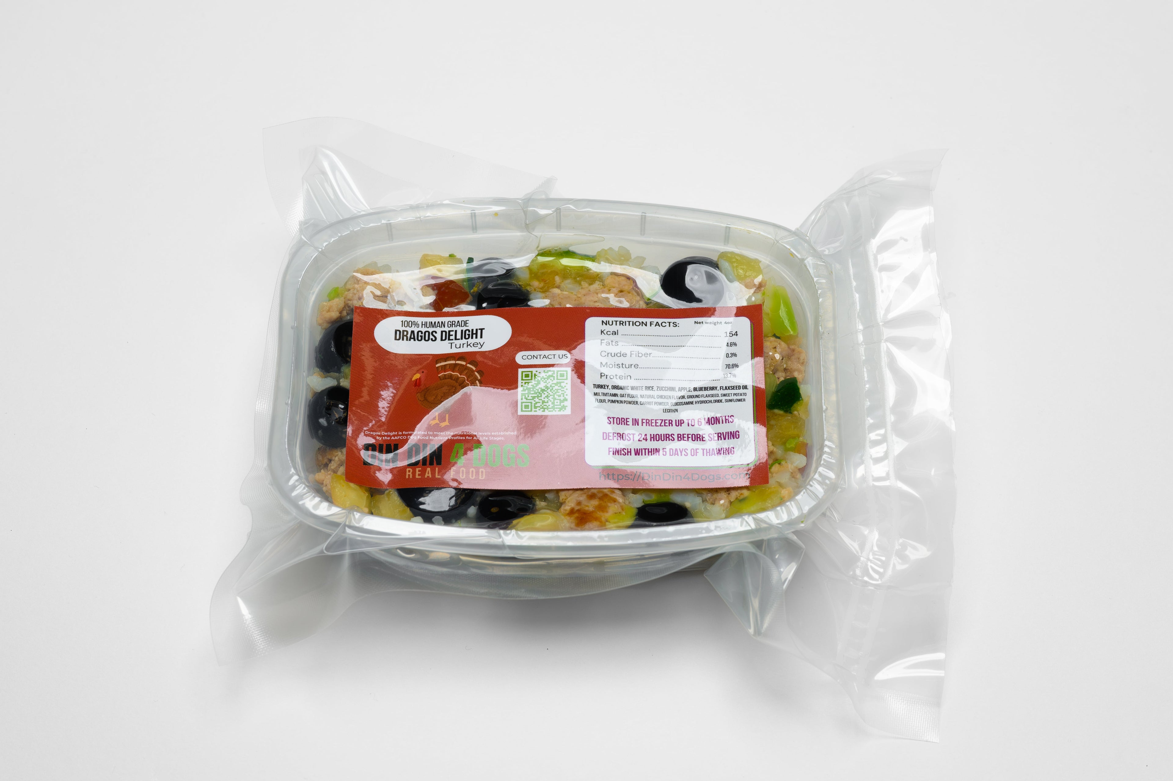 Packaged salad in a clear container with a label on a white background