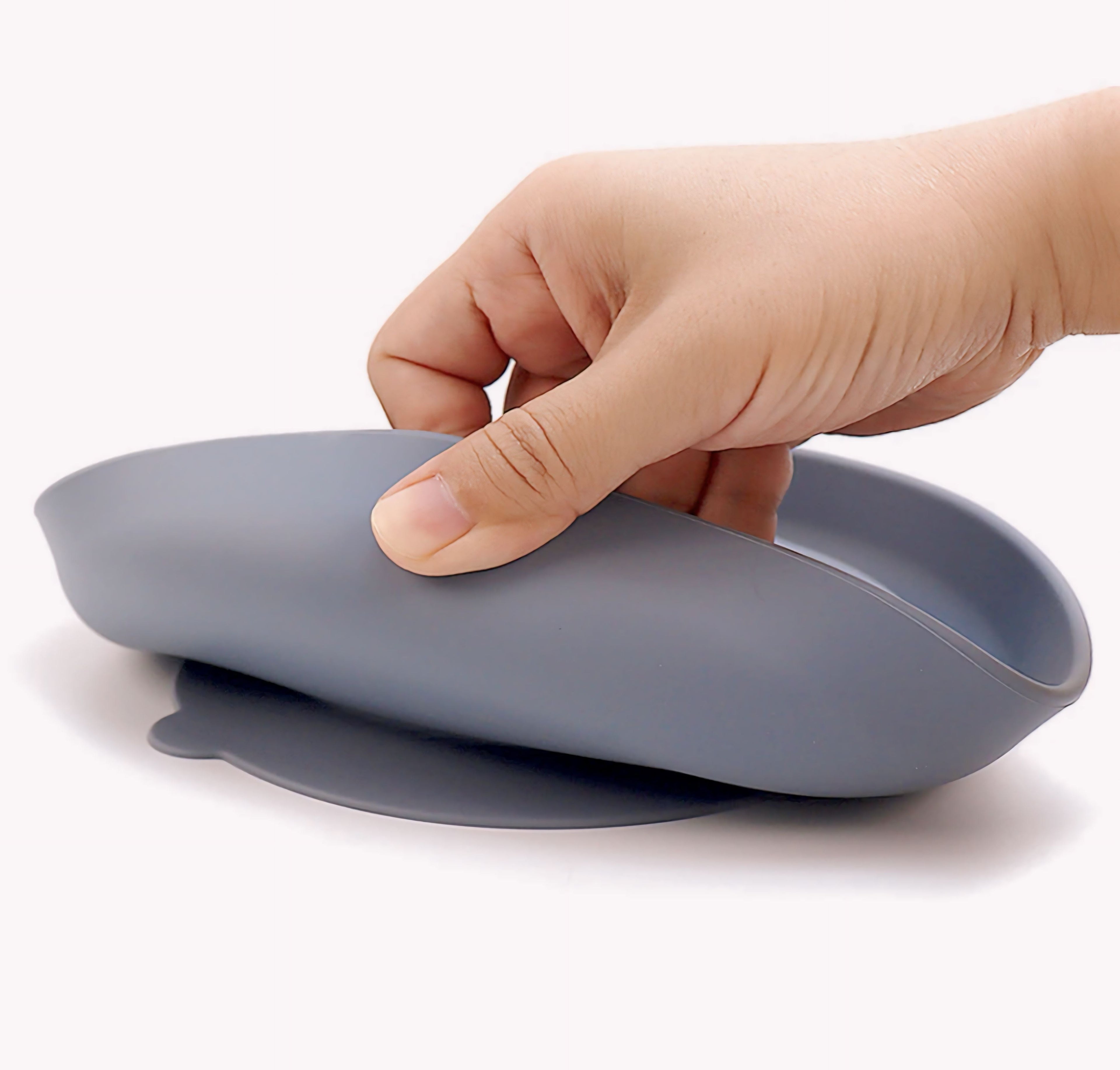 Hand holding a gray silicone cup with a white background