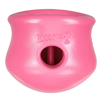 Pink dog toy with a central hole on a white background