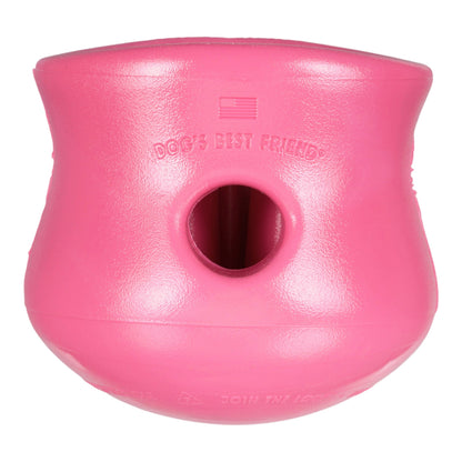 Pink dog toy with a central hole on a white background