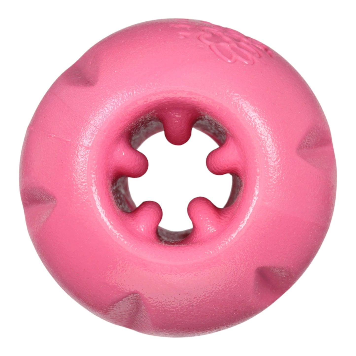 Pink rubber dog toy with a central hole on a white background