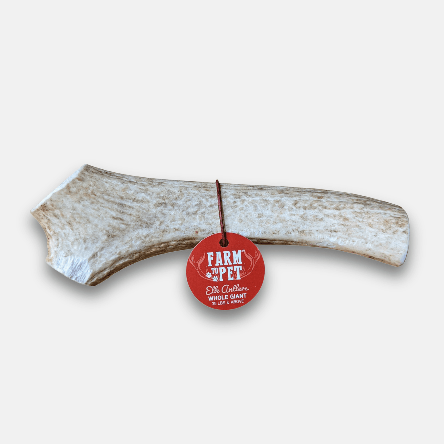 Rawhide bone with a 'Farm to Pet' tag on a white background