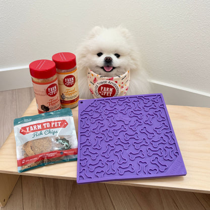 Purple textured mat on a table with 'Farm to Pet' products and a small white dog.