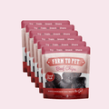 Multiple packages of Farm to Pet Beef Chips on a light pink background