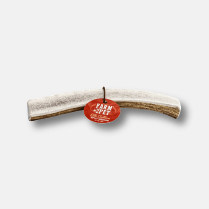 Rawhide bone with a red tag on a white background