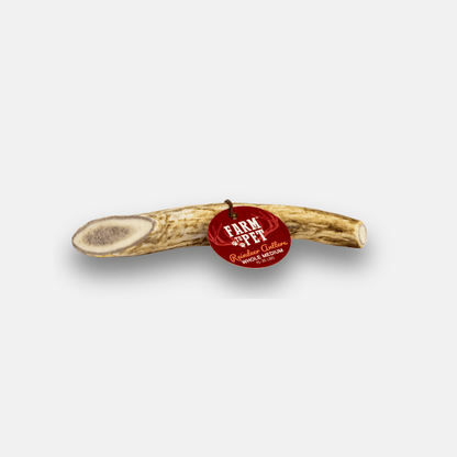 Wooden antler with a red 'Farm Pet' tag on a white background