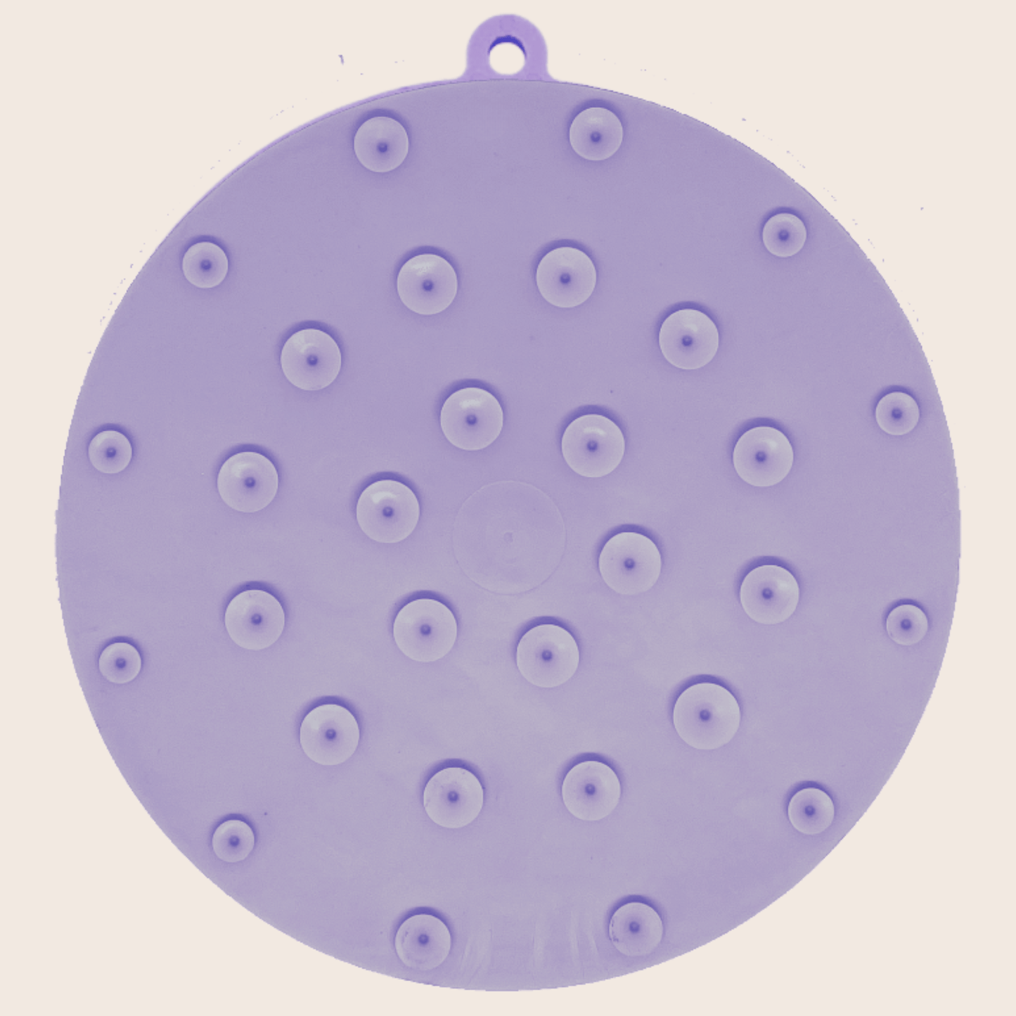 Purple silicone mat with suction cups on a beige background
