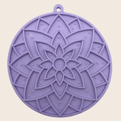 Purple silicone trivet with mandala design on a beige background