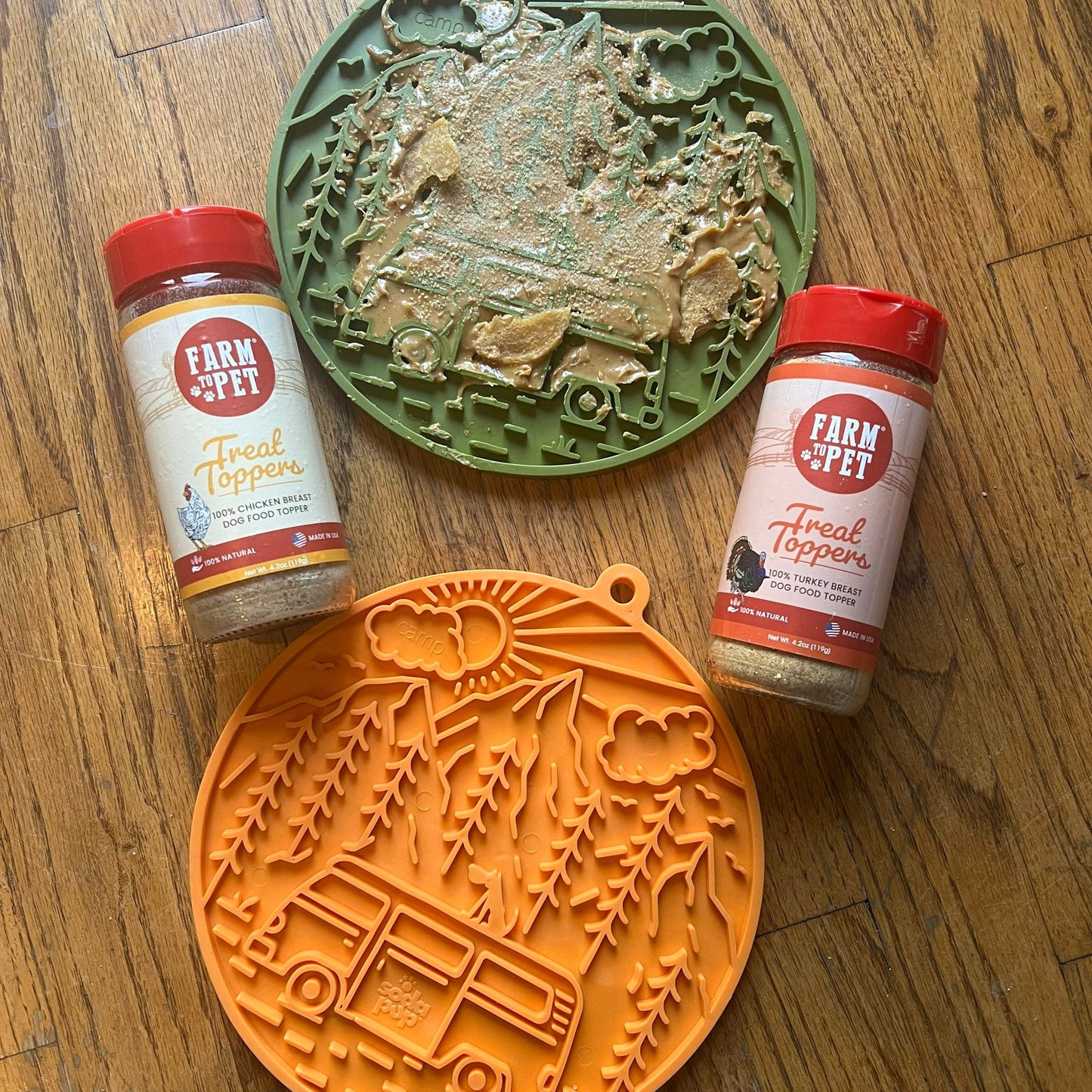 Two jars of 'Farm & Pet Treat Topper' with decorative cookie cutters on a wooden surface.