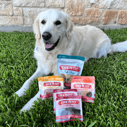 Dog sitting on grass with 'Farm to Pet' pet food packages