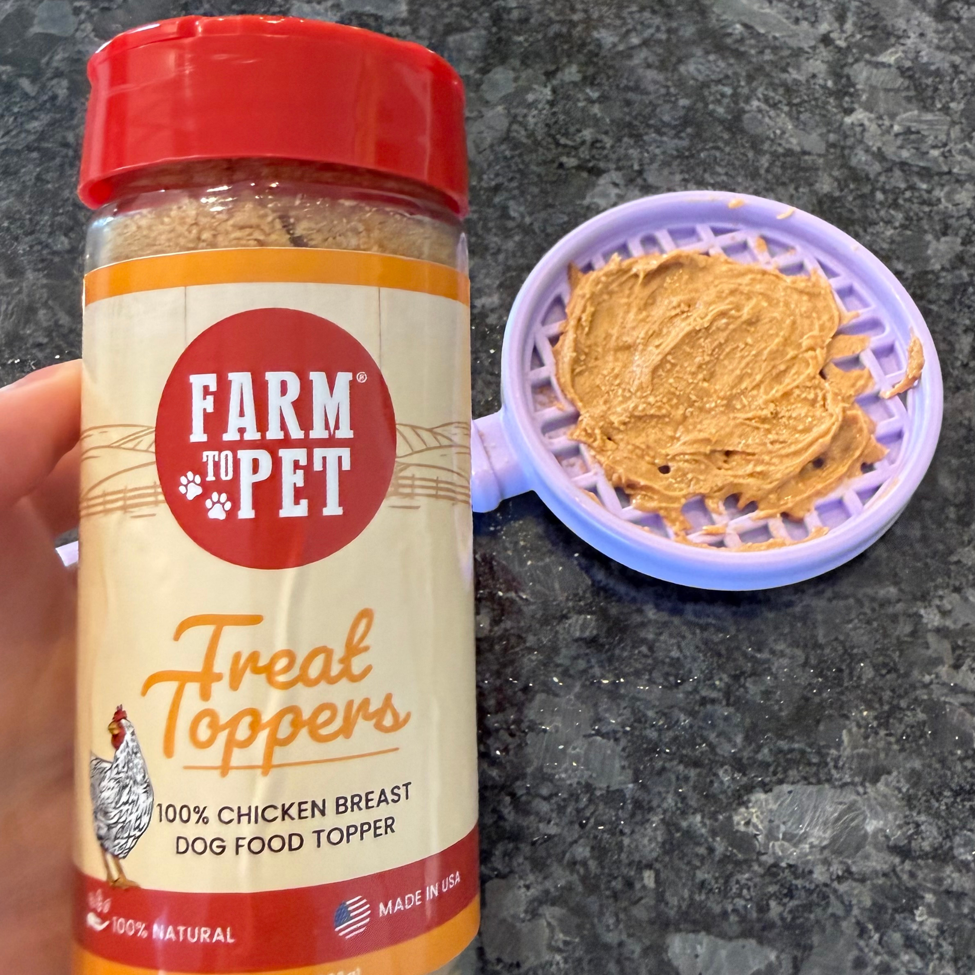 Farm to Pet Treat Toppers jar with a sample on a gray surface