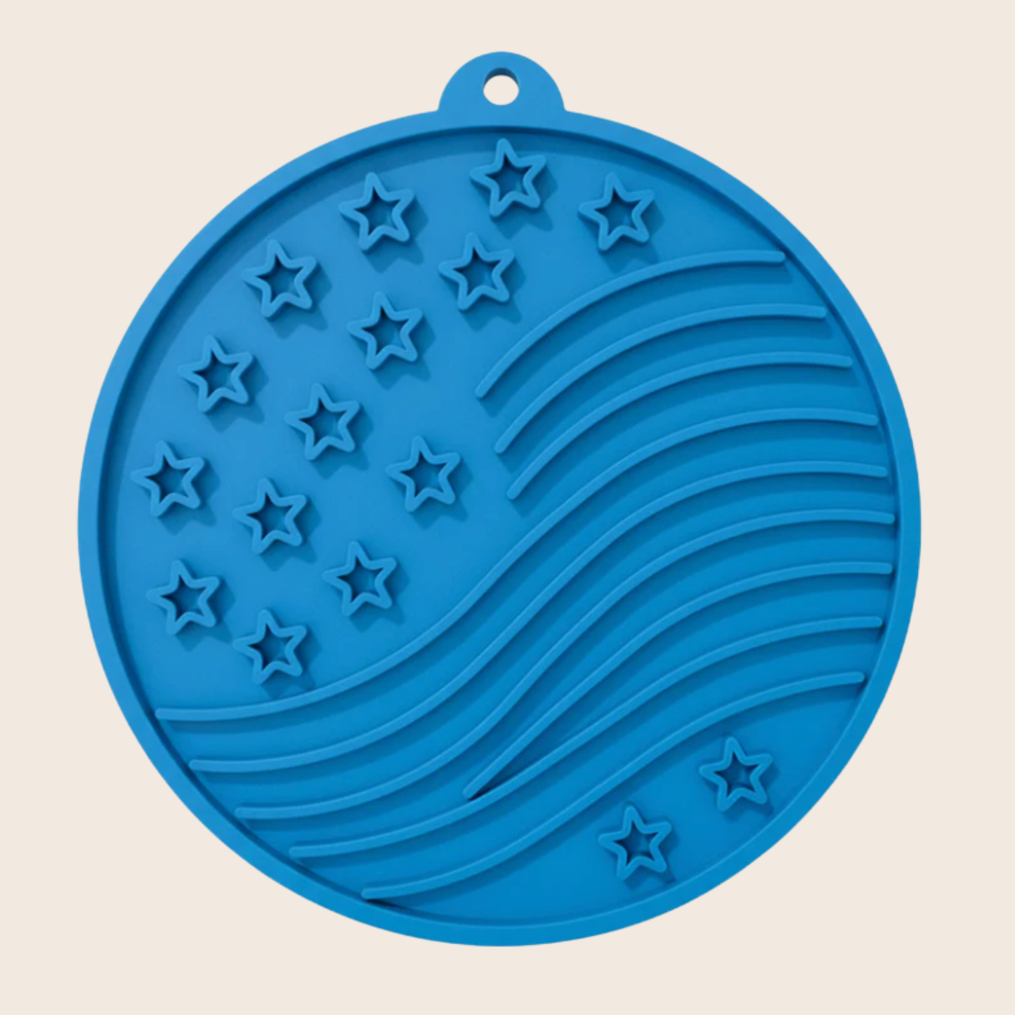 Blue silicone mat with star and stripe pattern on a beige background