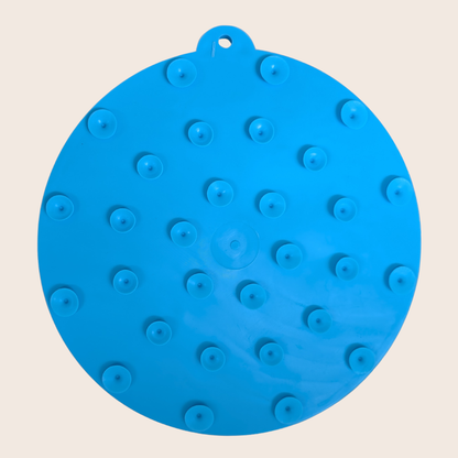 Blue silicone mat with raised circular nodes on a beige background