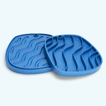 Two blue silicone mats with textured surface on a light gray background