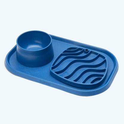 Blue silicone mat with a bowl on a light blue background